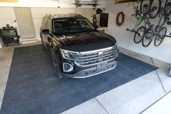 An SUV parked in the garage on the multi surface floor protector