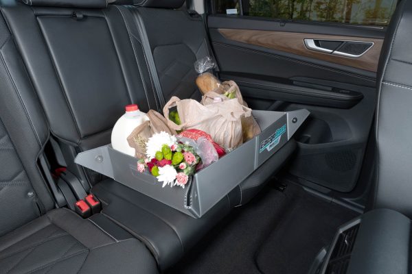 The Cargoboss Snap open storage containing groceries in an organized manner in the back seat.