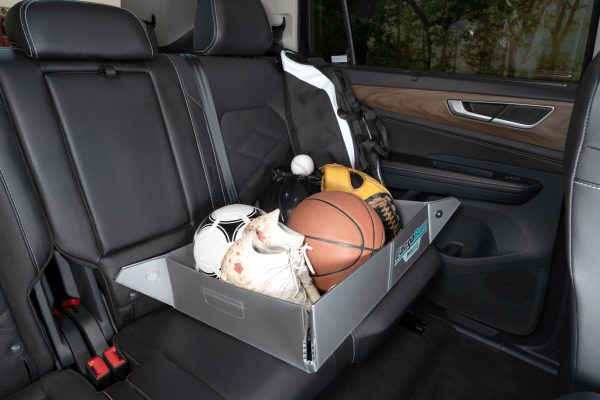 The Cargoboss Snap open storage containing sport equipment in an organized manner in the backseat.