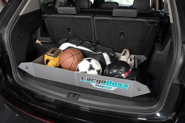 The Cargoboss Snap open storage containing sport equipment in an organized manner in the trunk of an SUV.