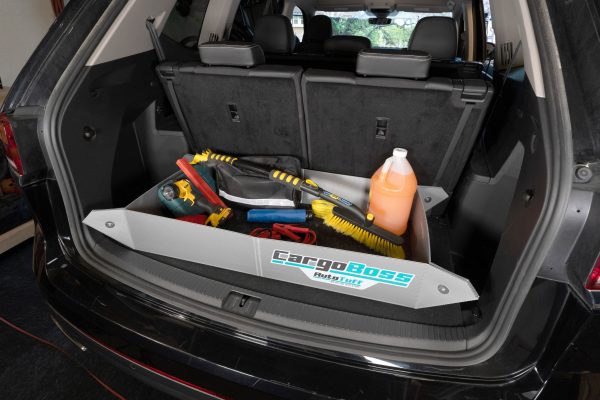 The Cargoboss Snap open storage containing car supplies and tools in an organized manner in the trunk of an SUV.