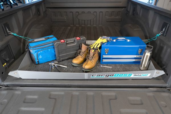 The Cargoboss snap open storage hooked into the back of a pick up truck containing a labor man's tools and equipment. Keeping them clean and organized.
