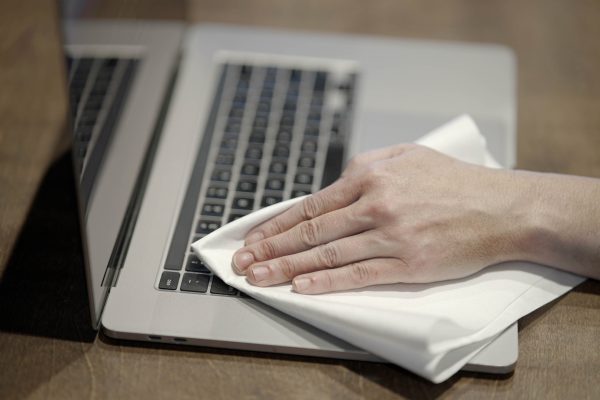 A Ragboss washable rag dusting of a laptop keyboard.