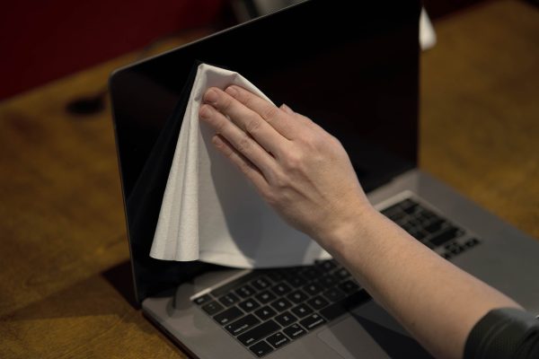 A Ragboss washable rag dusting of a laptop screen showing the range of safety for all surfaces.