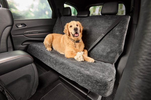 A dog sitting in the backseat of a car on the Petboss Seat Shields. Containing the dog hair and any mess made from touching the seats.